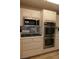 Modern kitchen with stainless steel microwave and double oven at 9917 Arbuckle Dr, Las Vegas, NV 89134