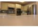 Modern kitchen with stainless steel microwave, oven, and refrigerator at 9917 Arbuckle Dr, Las Vegas, NV 89134
