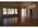 Bright living room with hardwood floors, large windows, and a stylish chandelier at 9917 Arbuckle Dr, Las Vegas, NV 89134
