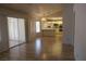 Open-concept living area with hardwood floors, connecting to the kitchen and sunroom at 9917 Arbuckle Dr, Las Vegas, NV 89134