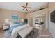 Staged main bedroom with plank floors, sitting area, and serene decor at 9917 Arbuckle Dr, Las Vegas, NV 89134