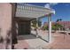 Covered patio with pergola featuring desert landscaping in the background at 9917 Arbuckle Dr, Las Vegas, NV 89134