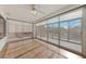 Bright sunroom with large windows, ceiling fan, and hardwood floors overlooking the backyard at 9917 Arbuckle Dr, Las Vegas, NV 89134