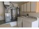 Utility room featuring a washer, dryer, and water heater at 9917 Arbuckle Dr, Las Vegas, NV 89134