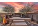Serene backyard setting with an outdoor fireplace and cozy seating, perfect for relaxation at 109 Reverie Heights Ave, Henderson, NV 89011