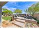 Stylish backyard featuring modern outdoor seating, a sleek fireplace, and desert landscaping at 109 Reverie Heights Ave, Henderson, NV 89011