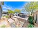 Stylish backyard featuring modern outdoor seating, a sleek fireplace, and desert landscaping at 109 Reverie Heights Ave, Henderson, NV 89011