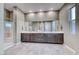 Bathroom featuring double sinks, spacious countertops, a walk-in shower, and gray tile flooring at 109 Reverie Heights Ave, Henderson, NV 89011