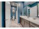 Blue-toned bathroom featuring a spacious vanity, modern fixtures, and access to a separate toilet and shower area at 109 Reverie Heights Ave, Henderson, NV 89011