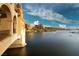 Picturesque waterfront view of luxury apartments and boat docks under a partly cloudy sky at 109 Reverie Heights Ave, Henderson, NV 89011
