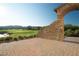 Outdoor patio featuring desert landscaping and a charming stone archway at 109 Reverie Heights Ave, Henderson, NV 89011