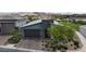 Contemporary home with desert landscaping, a two-car garage and a stone accent wall at 109 Reverie Heights Ave, Henderson, NV 89011