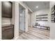 Bright hallway with wood-look flooring, storage cabinets, and stylish decor at 109 Reverie Heights Ave, Henderson, NV 89011