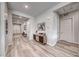 Hallway with wood floors, accent console, and access to other rooms at 109 Reverie Heights Ave, Henderson, NV 89011