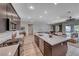 Modern kitchen featuring a large island, stainless steel appliances, and an open layout to the living and dining areas at 109 Reverie Heights Ave, Henderson, NV 89011
