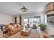 Cozy living room with a leather couch, pool table, and sliding glass doors to the patio at 109 Reverie Heights Ave, Henderson, NV 89011