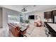 Open-concept living space featuring a modern entertainment center and leather seating with patio access at 109 Reverie Heights Ave, Henderson, NV 89011