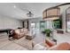 Spacious living room with a comfortable sofa, stylish decor, and sliding glass doors to the outdoor patio at 109 Reverie Heights Ave, Henderson, NV 89011