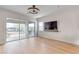 Living room with backyard view through sliding glass doors and a wall-mounted television at 109 Reverie Heights Ave, Henderson, NV 89011