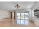 Bright living room featuring modern light fixture, wood floors, and sliding door access to a patio at 109 Reverie Heights Ave, Henderson, NV 89011