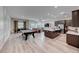 Spacious open floor plan including a pool table, a dining table, living room, and kitchen with modern appliances at 109 Reverie Heights Ave, Henderson, NV 89011