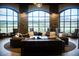 Elegant lounge area with comfortable seating, stone columns, and large windows at 109 Reverie Heights Ave, Henderson, NV 89011