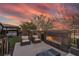Relaxing backyard with a cozy fireplace, hot tub, and comfortable seating at 109 Reverie Heights Ave, Henderson, NV 89011
