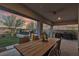 Expansive covered patio with a beautiful outdoor dining set and a built-in outdoor kitchen at 109 Reverie Heights Ave, Henderson, NV 89011