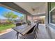 Covered patio with an outdoor dining area, ceiling fan, and views of the desert landscape at 109 Reverie Heights Ave, Henderson, NV 89011
