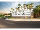 Entrance sign to Lake Las Vegas with palm trees and lush landscaping at 109 Reverie Heights Ave, Henderson, NV 89011