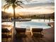 Resort style pool with a view of the sunset over the mountains at 109 Reverie Heights Ave, Henderson, NV 89011