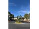 Community entrance featuring meticulously landscaped median and gated access for residents at 1205 Padre Serra Ln, Las Vegas, NV 89134