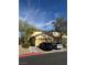 Charming two-story home featuring a tan exterior, attached garage, and low-maintenance desert landscaping at 1205 Padre Serra Ln, Las Vegas, NV 89134