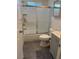 Clean bathroom featuring a shower-tub combo, gray wood-look floor tiles and a gray vanity with a sink at 1305 Shenandoah St, Boulder City, NV 89005