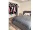 Comfortable bedroom featuring a gray cushioned headboard and a closet filled with clothes at 1305 Shenandoah St, Boulder City, NV 89005