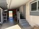 Exterior side patio view of the home with an entry door, steps and painted grey railing with trim at 1305 Shenandoah St, Boulder City, NV 89005