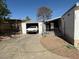 View of the home's driveway and detached garage, showing the side entry to the home and partial landscaping at 1305 Shenandoah St, Boulder City, NV 89005