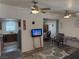 Open concept living room featuring wood-look flooring, ceiling fans and open views to the kitchen and dining area at 1305 Shenandoah St, Boulder City, NV 89005