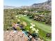 Aerial shot of a community featuring a golf course, luxury homes, and mountainous landscape at 15 Vintage Canyon St, Las Vegas, NV 89141