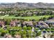 An aerial view of a neighborhood with manicured lawns and tree-lined streets at 15 Vintage Canyon St, Las Vegas, NV 89141