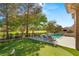Beautiful backyard featuring a pool, putting green, and comfortable lounge chairs with golf course views at 15 Vintage Canyon St, Las Vegas, NV 89141