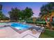 Beautiful backyard at dusk featuring a pool, lounge chairs, and golf course views at 15 Vintage Canyon St, Las Vegas, NV 89141