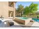 Resort-style backyard featuring a spa, pool, and lounge area at 15 Vintage Canyon St, Las Vegas, NV 89141