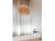 Stylish bathroom with a free-standing tub, bronze hardware, and white curtains at 15 Vintage Canyon St, Las Vegas, NV 89141