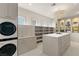 Large walk-in closet with washer, dryer, drawers and glass cabinets at 15 Vintage Canyon St, Las Vegas, NV 89141