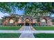 Charming two-story home with manicured lawn, landscape lighting, and beautiful stone archways at 15 Vintage Canyon St, Las Vegas, NV 89141