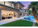 Beautiful two-story house with large sliding glass doors that open up to a backyard with a pool at 15 Vintage Canyon St, Las Vegas, NV 89141
