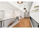 Long upstairs hallway showcasing hardwood floors, recessed lighting and black railings at 15 Vintage Canyon St, Las Vegas, NV 89141