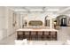 Stylish kitchen boasting a large island with seating, custom cabinetry, and seamless flow to other areas at 15 Vintage Canyon St, Las Vegas, NV 89141