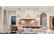 Kitchen/Living room with lots of light, featuring a large island with seating and neutral color palette at 15 Vintage Canyon St, Las Vegas, NV 89141